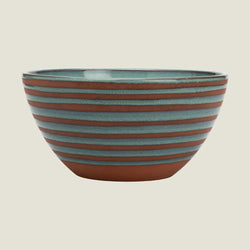 A round ceramic bowl with horizontal terracotta-colored and muted blue-green glazed stripes, shown against a plain white background.