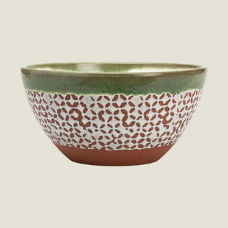 A ceramic bowl with a textured pattern, featuring a glossy olive green interior and rim, a white middle section covered in small brown leaf-like speckles, and a solid terracotta brown base.