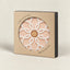 A ceramic pot base with a white geometric floral pattern and a cork center, presented inside a kraft paper box with a circular cutout. The box has black side panels and reads 'FERAMIC POT BASE' and 'MADE IN PORTUGAL'.