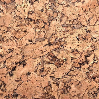 A close-up texture of cork material with a natural, organic pattern in shades of tan, brown, and beige.