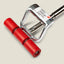 A close-up of a red and silver mechanical tool, likely a mounting block or clamp, with three red cylindrical pads and a polished metal frame, shown on a light beige background.