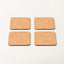 Four rectangular cork coasters with rounded corners arranged in a 2x2 grid on a plain white background.