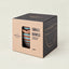 Packaged set of two small ceramic bowls in a kraft paper box with a clear window showing the striped bowls inside, on a light beige background.