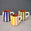 A set f 3 mini jugs with bold stripes each one with different colours.