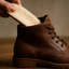 Slidding in sheepskin and cork insoles into a men's letaher boots