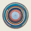 A round braided placemat with concentric circular patterns in multiple colors, including blue, pink, orange, green, white, and black, on a light beige background.